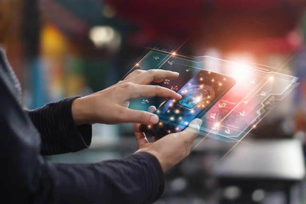 Person interacts with phone displaying holographic fingerprint and digital financial analytics interface.