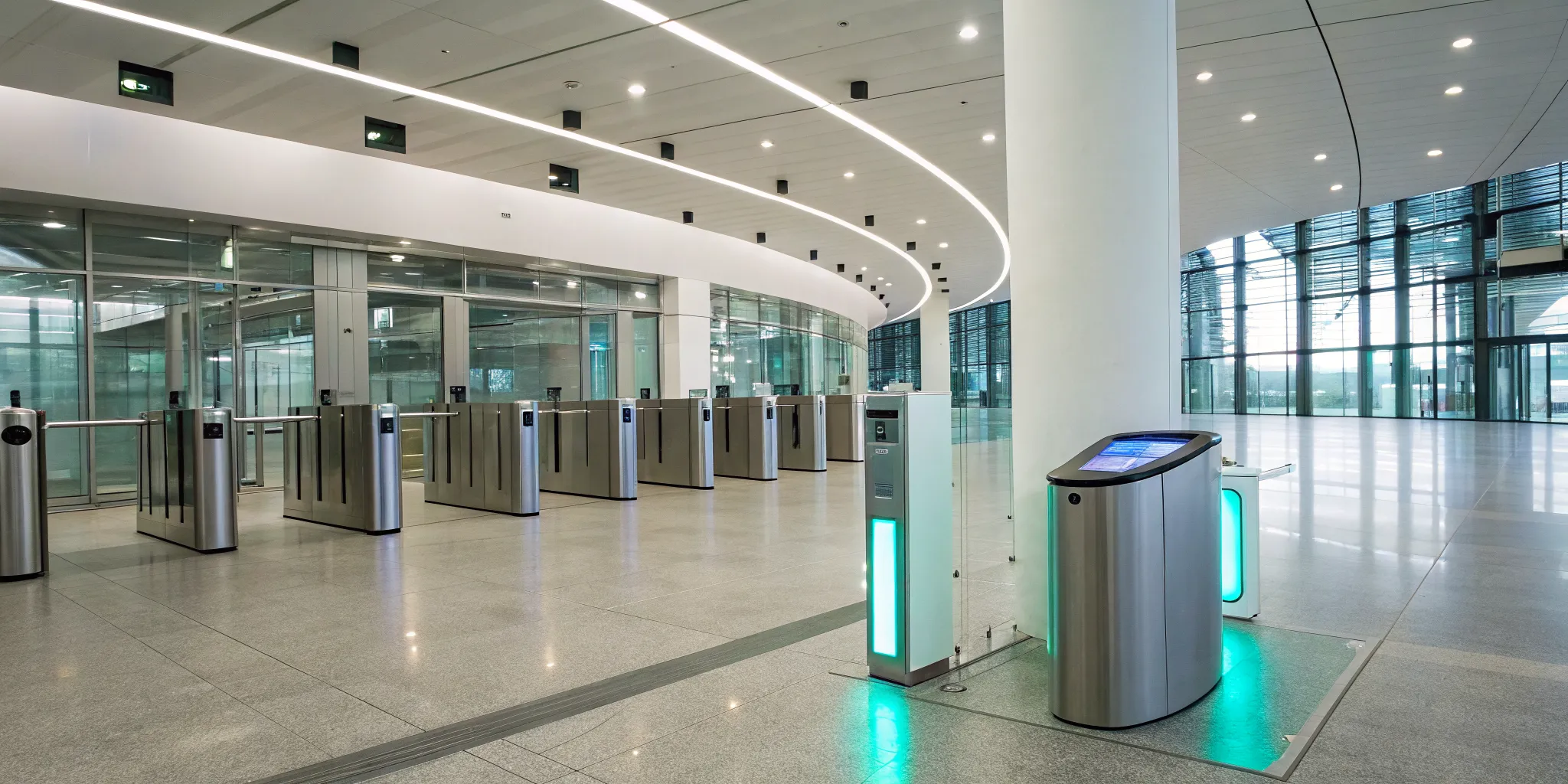 An integrated security system's access control gates securing a modern building lobby.
